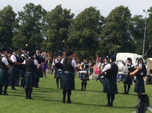 Pipers and drummers doing their thing as runners cross the finish line